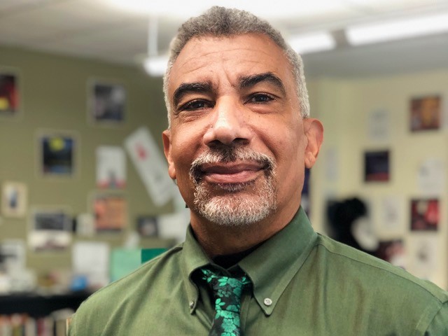 Mr. Stephen Wicker ready to welcome students into his English classroom.