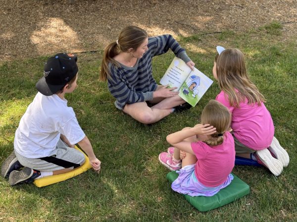 Sophomore Maisy Bedell reads to lower school students