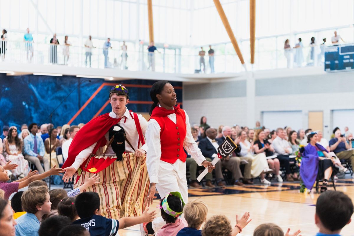 Seniors Patrick Ritter and Zora Burrell receive high fives from lower school students
