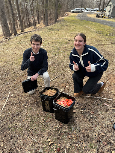 Cecelia Russell '27 and Josh Reinecke '27 show off buckets full of plantains which SEA will compost.